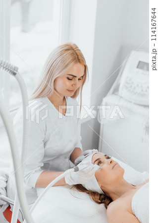 A cosmetologist, a true professional, uses vacuum and RF lifting to provide the client with effective and safe procedures that solve the problems of skin aging. 114167644