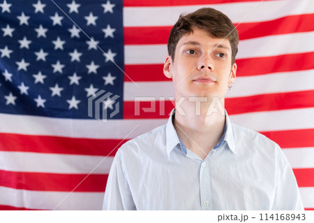 Young guy posing in front of USA flag Young guy posing in front of USA flag 114168943