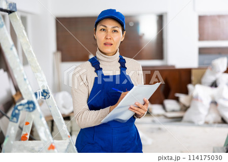 Portrait of an asian builder woman who checks completed work on Portrait of an asian builder woman who checks completed work on 114175030