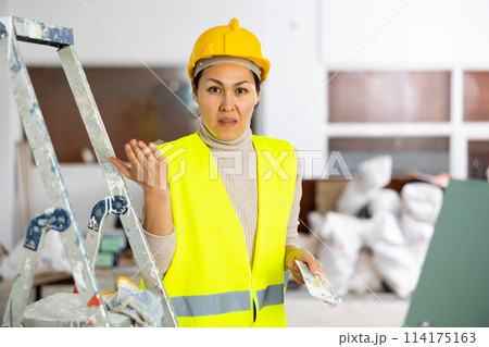 Woman builder frustrated by her wage 114175163
