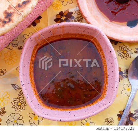 Hearty Tunisian soup Chorba Frik in ceramic plate 114175323
