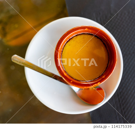 In center of frame is portion of yogurt decorated with liquid honey of golden color In center of frame is portion of yogurt decorated with liquid honey of golden color 114175339