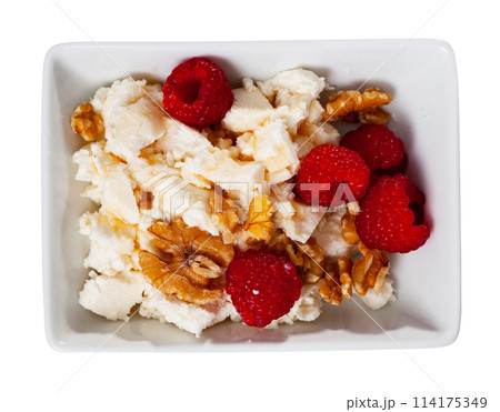 Farm cottage cheese filled with large amount of honey with walnut and raspberry 114175349