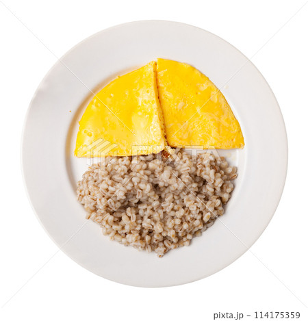 Boiled pearl barley with omelette served on dish on checkered cloth 114175359