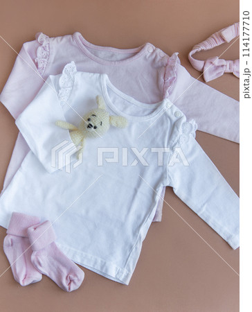 Set of pink clothes and accessories for newborn baby. Knitted toys rabbit and dog, romper, socks and handband 114177710