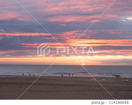 Oostende, Belgium - July 31st 2023: View over the city beach during sunset. Oostende, Belgium - July 31st 2023: View over the city beach during sunset. 114180088