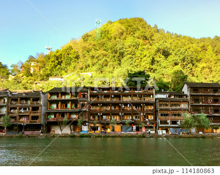 Row Of Ancient Houses On The Banks Of Tuojiang River In Fenghuang Ancient Town. Fenghuang Ancient Town Is One Of The Most Famous Old Towns In China. Row Of Ancient Houses On The Banks Of Tuojiang River In Fenghuang Ancient Town. Fenghuang Ancient Town Is One Of The Most Famous Old Towns In China. 114180863