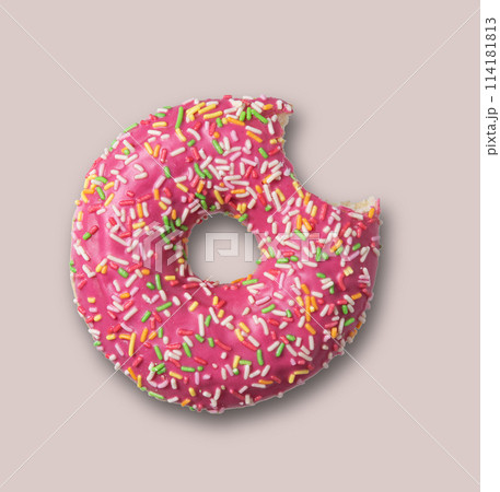 Delicious glazed pink bite doughnut with sprinkles on gray background Delicious glazed pink bite doughnut with sprinkles on gray background 114181813