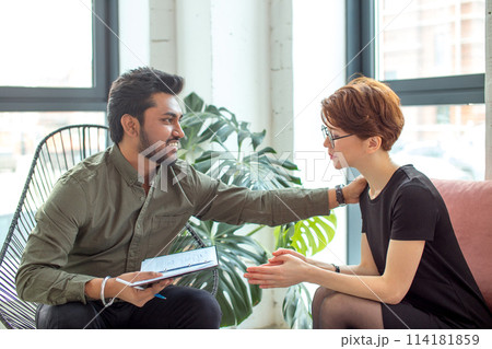 Therapist cheering up his extremely depressed patient 114181859
