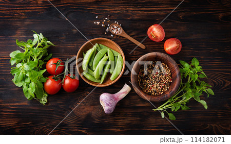 Healthy  food. Fresh aromatic basil, garkic, tomato and spicy pepper  on wood plate 114182071