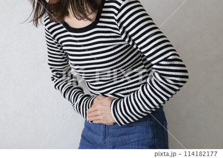 お腹を抑える女性　腹痛イメージ 114182177