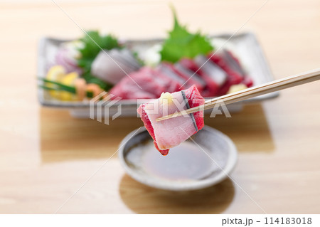 ミンク鯨の赤身と本皮のお刺身をお醤油につける 114183018