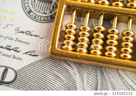 Gold abacus on US dollar banknote money, economy finance exchange trade investment. 114183113