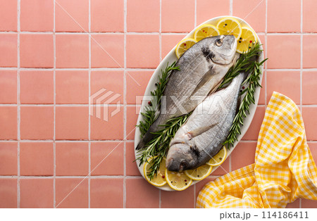 Dorada fish on a pink background Dorada fish on a pink background 114186411