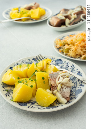 Boiled potatoes with pickled herring and sauerkraut Boiled potatoes with pickled herring and sauerkraut 114186432