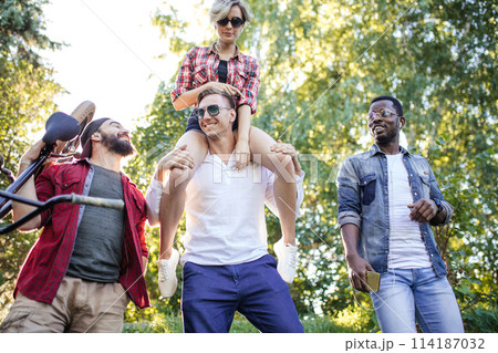 Diverse students relaxing outdoor after classes in college campus. 114187032