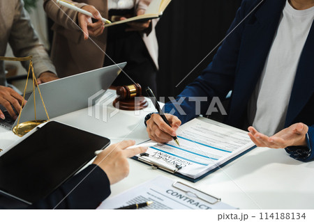 Business people and lawyers discussing contract papers sitting in the table at office in the morning. concepts of law, advice, legal services. 114188134