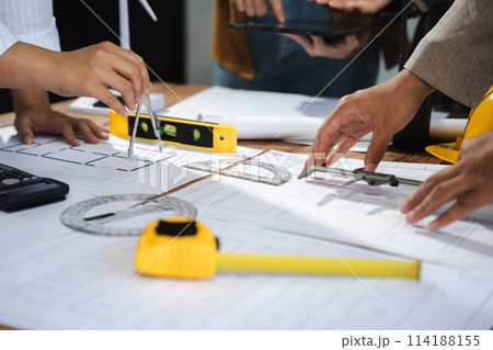 architect or engineer working on table use drawing tool on the paper plan for business architectural project. 114188155