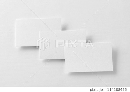 Mockup of three business cards row at white textured paper background. Mockup of three business cards row at white textured paper background. 114188436