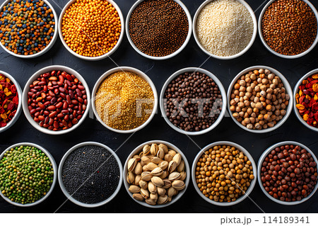 A variety of spices are placed in the bowls, ready to be used as ingredients for creating flavorful dishes. Spices are essential for enhancing the taste of food recipes across different cuisines 114189341