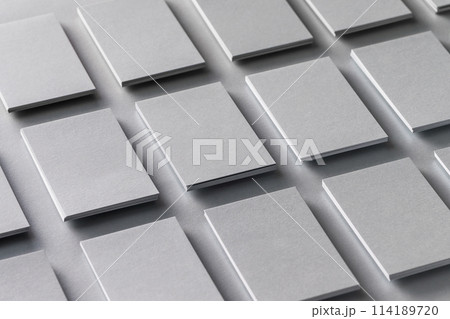 Mockup of vertical business cards stacks arranged in rows at grey textured paper background. Mockup of vertical business cards stacks arranged in rows at grey textured paper background. 114189720