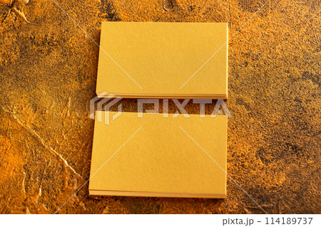 Mockup of two horizontal golden foil business cards at golden textured luxury background. 114189737