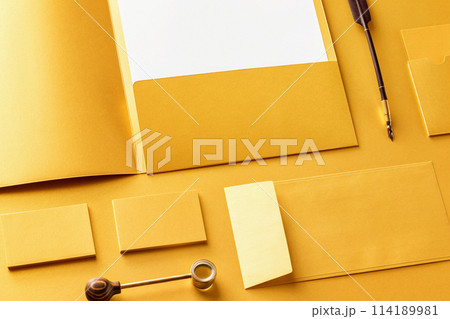 Corporate stationery set mockup. Presentation folder, letterhead, envelope and business cards at golden textured foil paper background. 114189981