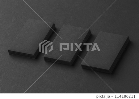 Mockup of three vertical business cards stacks at black textured background. 114190211