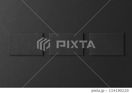 Mockup of three blank business card stacks at black textured background. Mockup of three blank business card stacks at black textured background. 114190220