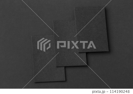 Mockup of three vertical business cards at black textured background. 114190248