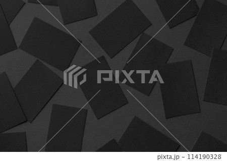 Top view mockup of horizontal business cards scattered at black textured paper background. Top view mockup of horizontal business cards scattered at black textured paper background. 114190328