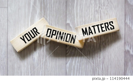 YOUR OPINION MATTERS is written on wooden blocks on a gray background. close-up YOUR OPINION MATTERS is written on wooden blocks on a gray background. close-up 114190444