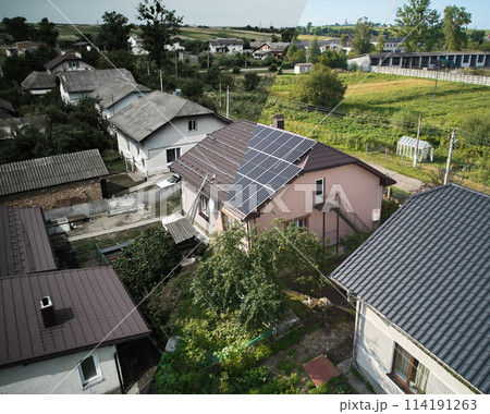 Collage of photos of installation and ready solar panels on the roof of house. Before and after concept. Modern technology and innovation. Idea of environment safety. Aerial view. 114191263