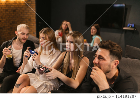 Men and women fully engrossed in unfolding drama of game 114191287