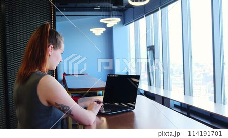 Employee checks significant document at shared workspace 114191701