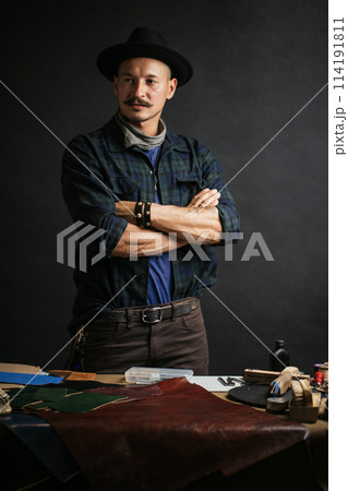 Professional shoemaker in his workshop making and repairing custom made shoes Professional shoemaker in his workshop making and repairing custom made shoes 114191811