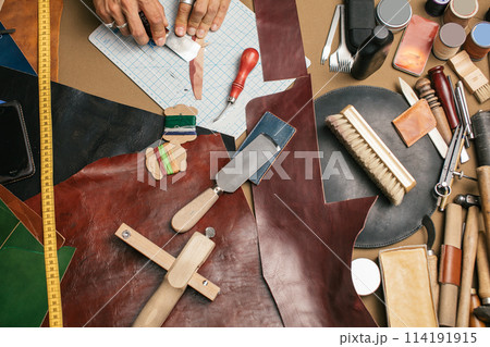 Close-up. Male hand master cut with a knife to skin products. Small business Close-up. Male hand master cut with a knife to skin products. Small business 114191915