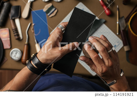 Working process of producing hand made leather wallet in the leather workshop. 114191921