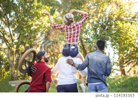 Young coupe in park. Boyfriend carrying his girlfriend on piggyback. Young coupe in park. Boyfriend carrying his girlfriend on piggyback. 114193303