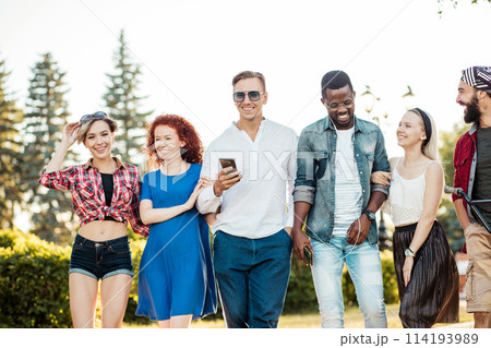 Best multiracial friends hanging out together and walking in park in summer day. 114193989