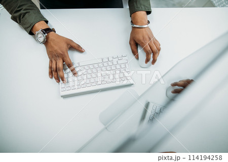 Man hand on computer keyboard on table top view Man hand on computer keyboard on table top view 114194258