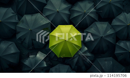a yellow umbrella is surrounded by black umbrellas 114195706