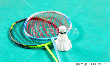 White badminton shuttlecocks and badminton rackets on green floor indoor badminton court soft and selective focus on shuttlecocks and the rackets White badminton shuttlecocks and badminton rackets on green floor indoor badminton court soft and selective focus on shuttlecocks and the rackets 114195968