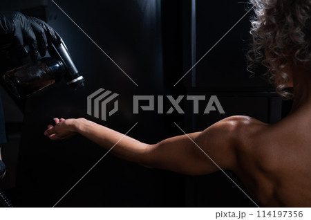The master applies tinting paint to the woman's hand. Instant tanning procedure The master applies tinting paint to the woman's hand. Instant tanning procedure 114197356