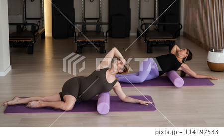 Two pregnant women doing yoga. Preparing for the birth of a child.  114197533