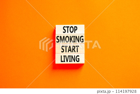 Stop smoking start living symbol. Concept words Stop smoking start living on cubes. Beautiful orange background. Medical healthy lifestyle stop smoking start living concept. Copy space. Stop smoking start living symbol. Concept words Stop smoking start living on cubes. Beautiful orange background. Medical healthy lifestyle stop smoking start living concept. Copy space. 114197928