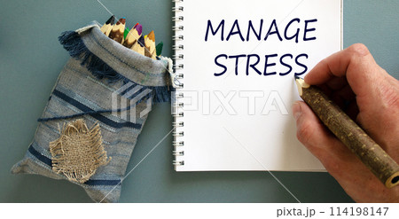 Manage stress symbol. Doctor writing concept words 'manage stress' on white note, isolated on blue background. Bunch of pencils stylized tree branch in bag. Psychological, manage stress concept. 114198147