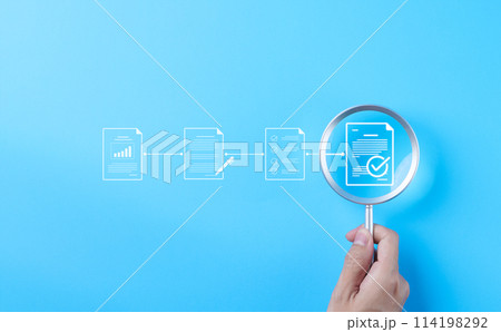Document review process and quality control concept. Hand holding magnifying glass over a document icon with checklist, Document review and approval. Certificate management, Audit, Standardization, Document review process and quality control concept. Hand holding magnifying glass over a document icon with checklist, Document review and approval. Certificate management, Audit, Standardization, 114198292