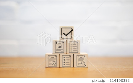 Document quality control concept. Wooden blocks stacked with icon correct sign mark with approve paperless and quality assurance approved. Checklist document analyst. Quality certificate management. 114198352