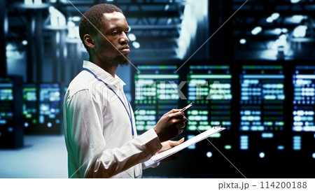 IT programmer using clipboard to assess supercomputer cybersecurity dangers arising due to unsecured network connections. Supervisor making sure high tech facility is invulnerable to malware attacks 114200188